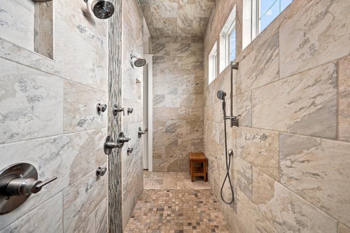 Oversized walk-in shower with multiple heads