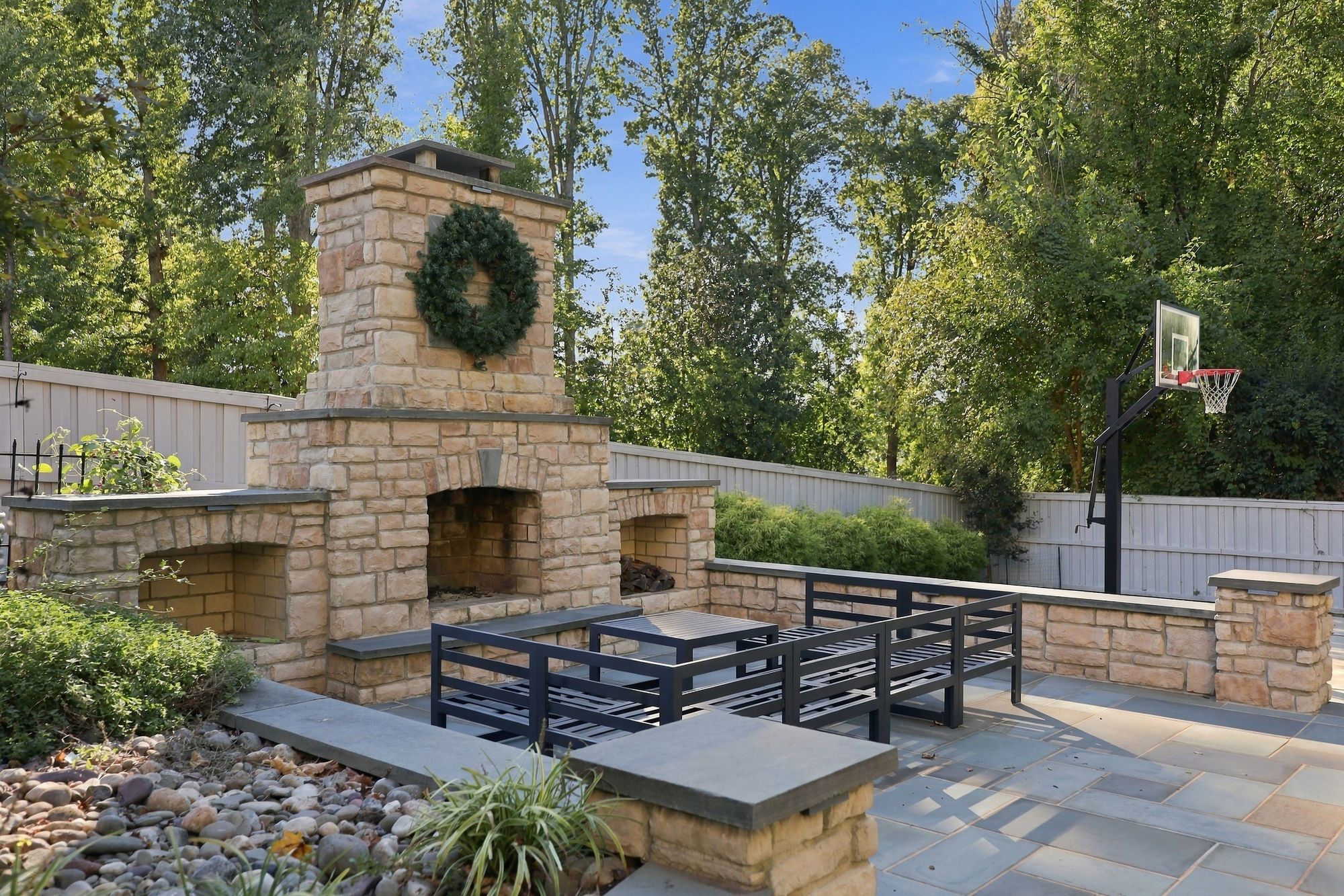 Bluestone terrace with stacked-stone outdoor fireplace